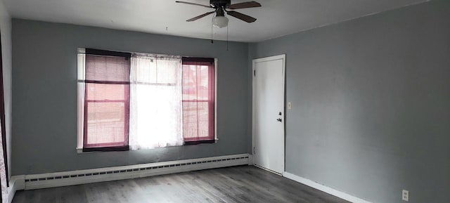 140 E Ave, Iron Ridge, WI 53035 - unfurnished room with baseboard heating, wood finished floors, baseboards, and a ceiling fan