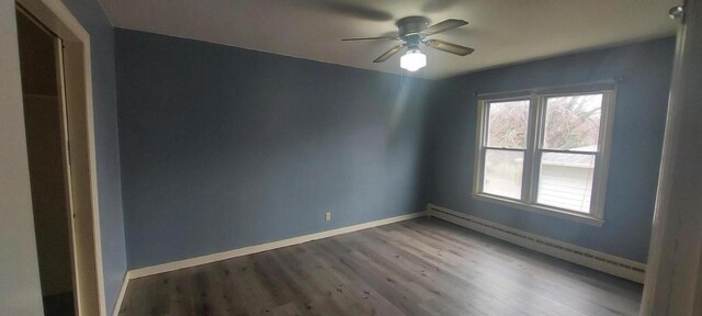 140 E Ave, Iron Ridge, WI 53035 - empty room with baseboards, a ceiling fan, plenty of natural light, and wood finished floors