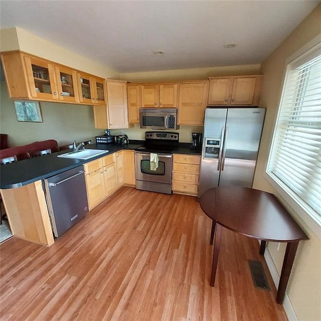 2856 29th Ave Unit 110, Birchwood, WI 54817 - kitchen with visible vents, light wood finished floors, light brown cabinets, and stainless steel appliances