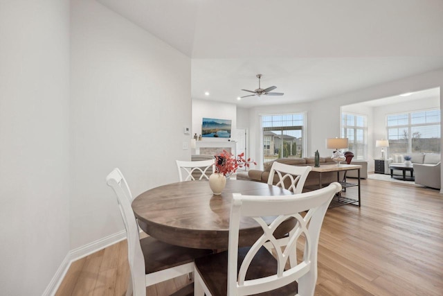 dining room featuring light wood-style flooring, ceiling fan, baseboards, and recessed lighting