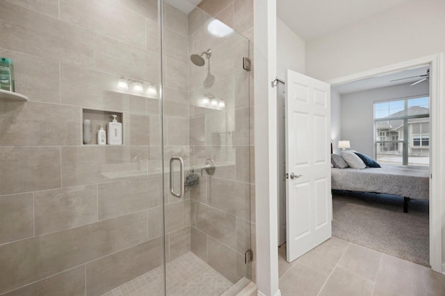 ensuite bathroom featuring a stall shower, ensuite bath, and tile patterned flooring