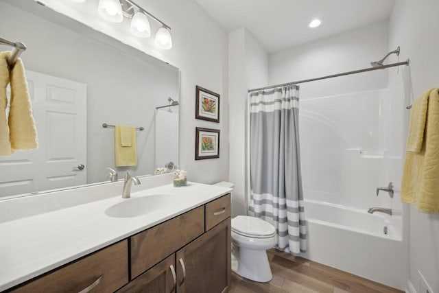 full bath featuring shower / bathtub combination with curtain, vanity, recessed lighting, toilet, and wood finished floors