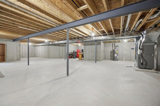 unfinished below grade area with electric water heater and heating unit
