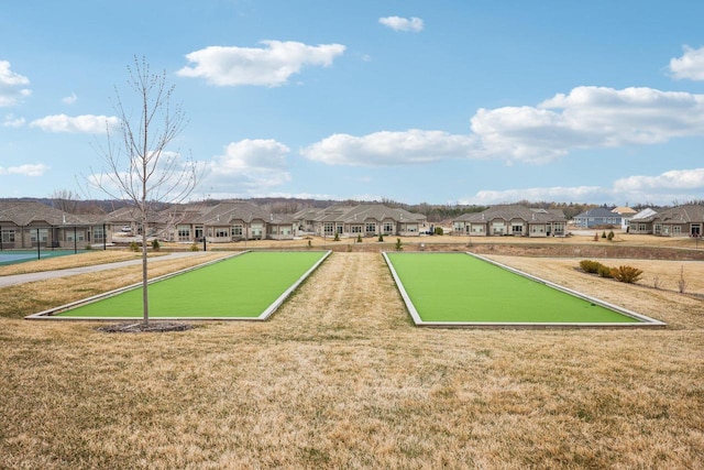 view of community featuring a residential view and a lawn