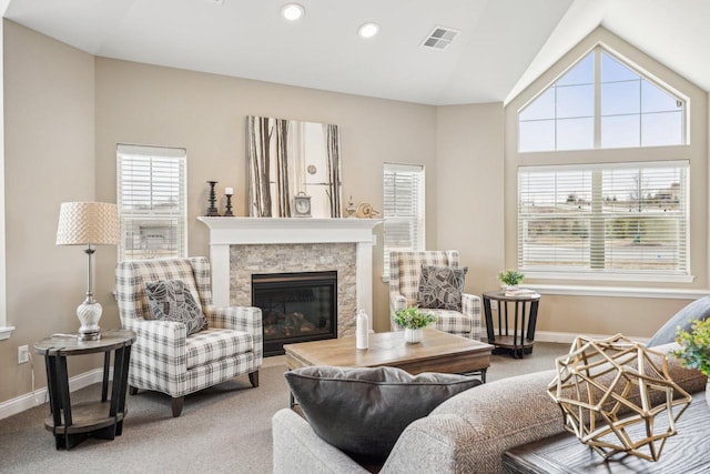 carpeted living area featuring a fireplace, visible vents, recessed lighting, lofted ceiling, and baseboards