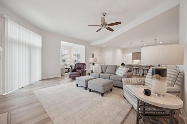 living area with recessed lighting, light wood-type flooring, baseboards, and ceiling fan