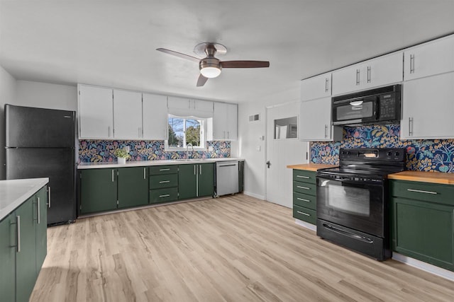 kitchen featuring green cabinetry, white cabinets, black appliances, and decorative backsplash