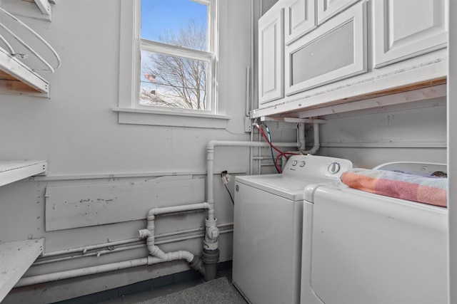washroom with washer and dryer, wainscoting, and cabinet space