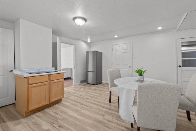 dining space with visible vents, baseboards, light wood finished floors, and recessed lighting