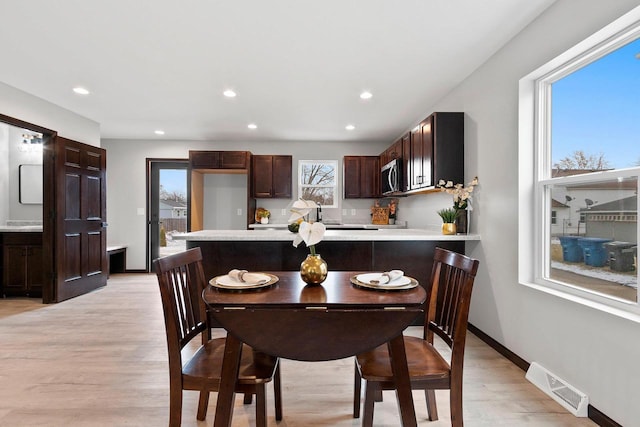 1143 Fillmore Ave, Oshkosh, WI 54902 - dining space with recessed lighting, visible vents, light wood finished floors, and baseboards