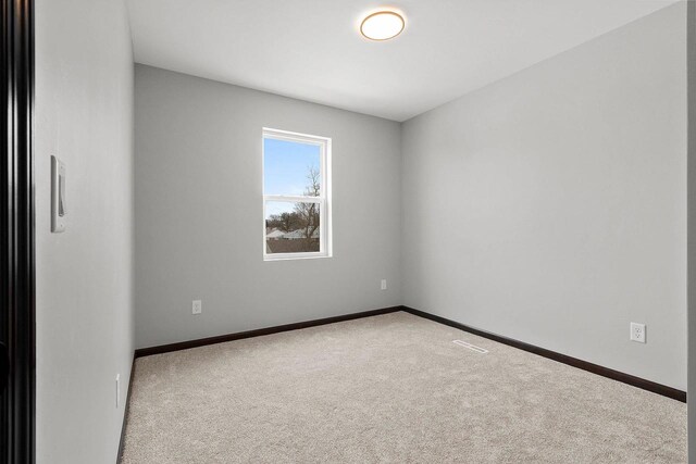 1143 Fillmore Ave, Oshkosh, WI 54902 - carpeted empty room with baseboards