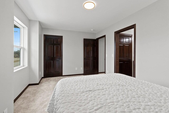1143 Fillmore Ave, Oshkosh, WI 54902 - bedroom featuring baseboards and light colored carpet