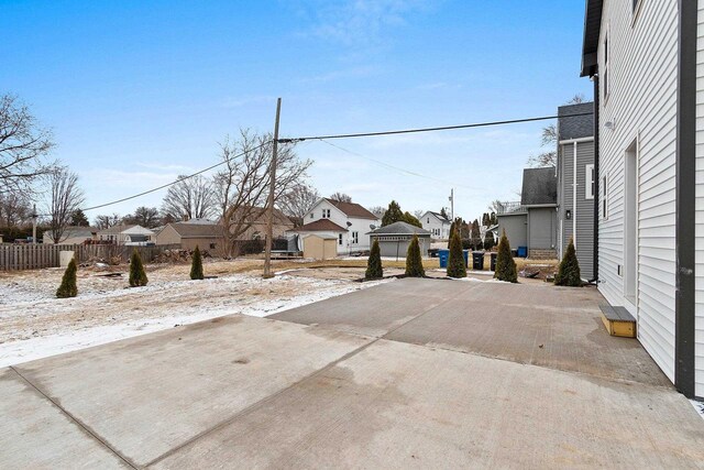 1143 Fillmore Ave, Oshkosh, WI 54902 - view of yard featuring fence, a residential view, and a patio