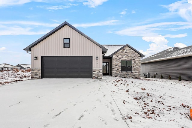 3106 Lazy Oak Dr, Green Bay, WI 54311 - modern inspired farmhouse with board and batten siding, a garage, and stone siding