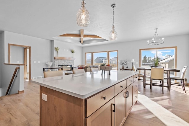 3106 Lazy Oak Dr, Green Bay, WI 54311 - kitchen featuring coffered ceiling, light wood-style floors, a notable chandelier, and a kitchen island