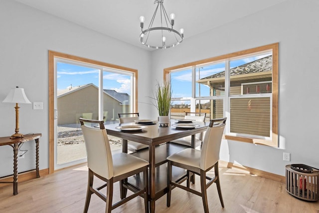 3106 Lazy Oak Dr, Green Bay, WI 54311 - dining room with a chandelier, light wood-style flooring, and baseboards