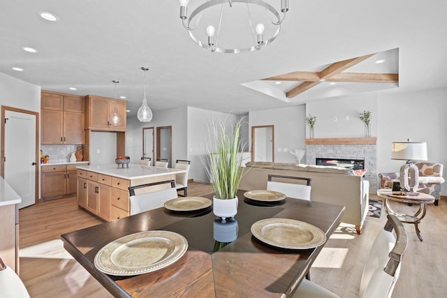3106 Lazy Oak Dr, Green Bay, WI 54311 - dining area with recessed lighting, light wood finished floors, a notable chandelier, and a stone fireplace