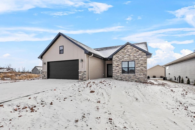 3106 Lazy Oak Dr, Green Bay, WI 54311 - view of front of property featuring a garage, stone siding, and board and batten siding