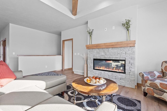 3106 Lazy Oak Dr, Green Bay, WI 54311 - living area with wood finished floors, a stone fireplace, and visible vents