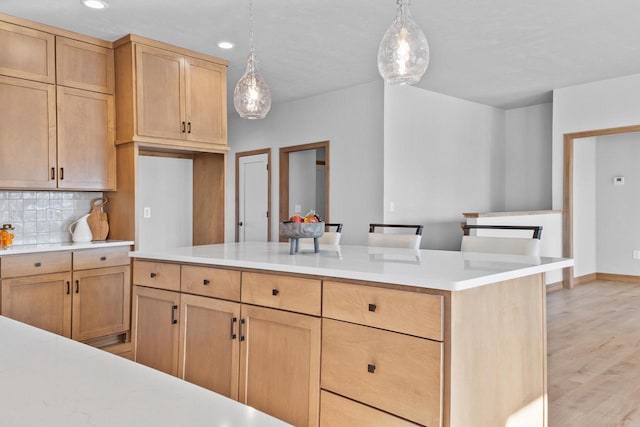 3106 Lazy Oak Dr, Green Bay, WI 54311 - kitchen with hanging light fixtures, light countertops, light brown cabinetry, light wood-style floors, and backsplash