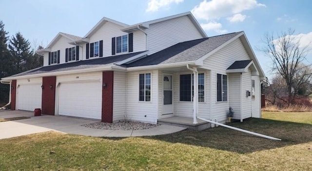 view of front facade featuring a front yard, an attached garage, and concrete driveway