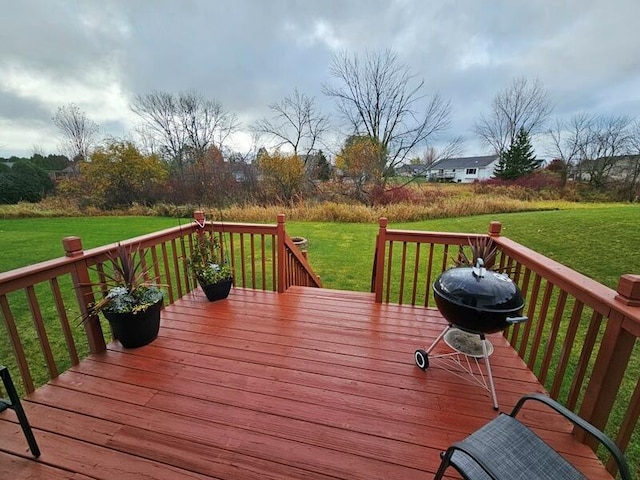 deck with grilling area and a lawn