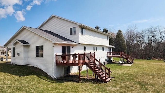 back of house with stairway, a wooden deck, and a lawn