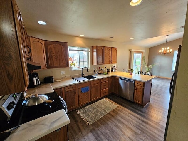kitchen featuring a notable chandelier, dishwasher, a sink, a peninsula, and dark wood finished floors