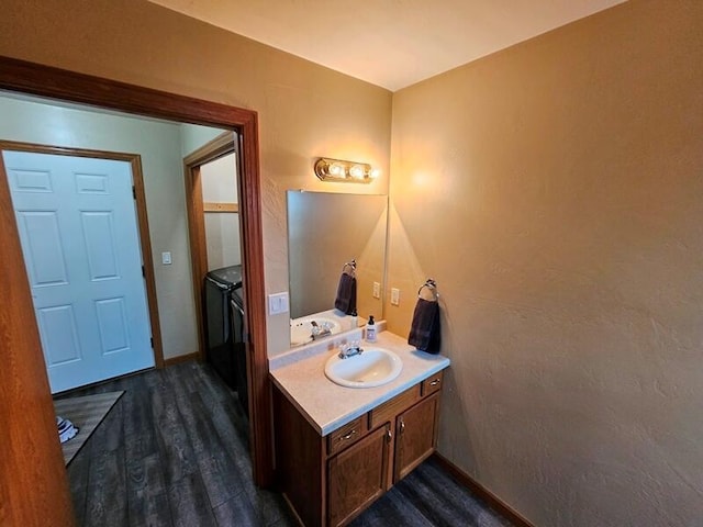 bathroom featuring wood finished floors, vanity, and baseboards