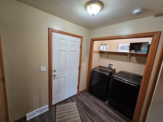 laundry room featuring laundry area, dark wood finished floors, visible vents, washer and dryer, and baseboards