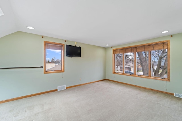 interior space with a wealth of natural light, visible vents, and carpet floors