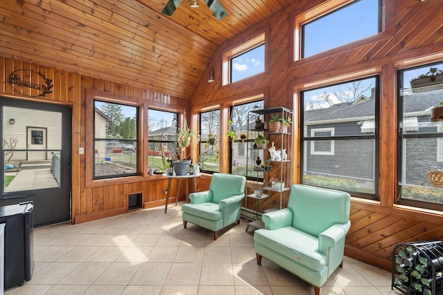 sunroom featuring wood ceiling, high vaulted ceiling, wood walls, and tile patterned flooring