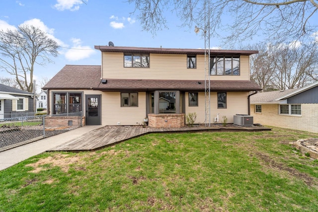 back of property featuring central AC, a lawn, fence, a shingled roof, and a deck