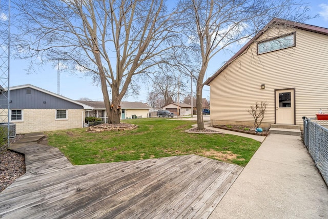 deck featuring central air condition unit, a yard, and fence