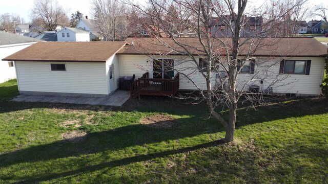 603 Mansion St, Mauston, WI 53948 - rear view of house featuring a wooden deck, a residential view, a lawn, and roof with shingles