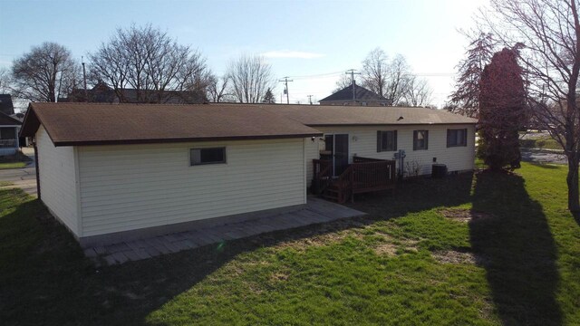 603 Mansion St, Mauston, WI 53948 - back of property featuring cooling unit, a lawn, and a deck