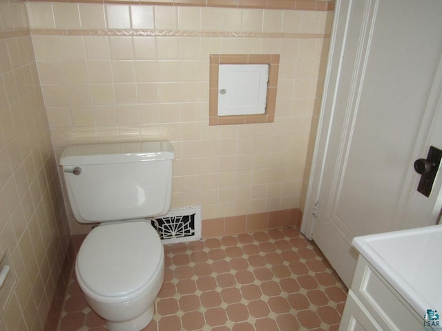 1125 N 22nd St, Superior, WI 54880 - bathroom with tile patterned floors, visible vents, tile walls, and toilet