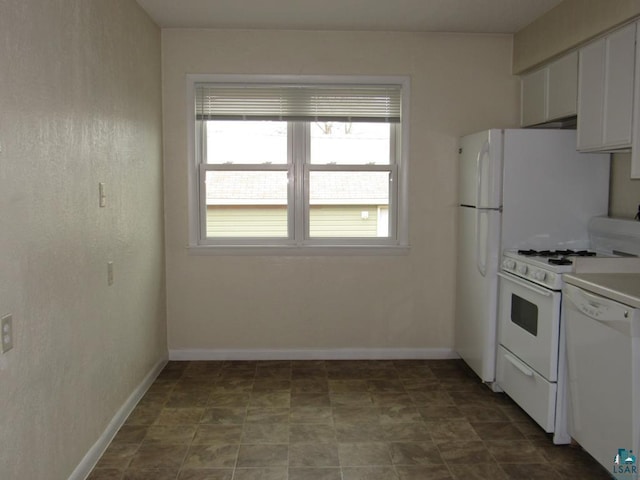 1125 N 22nd St, Superior, WI 54880 - kitchen featuring baseboards, white appliances, and white cabinets