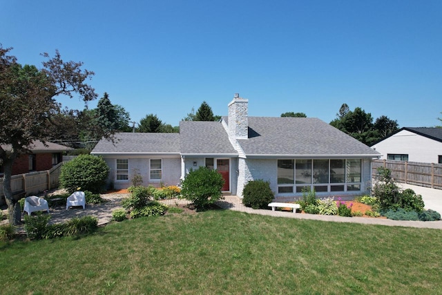 7744 2nd Ave, Kenosha, WI 53143 - ranch-style home with a front yard, fence, brick siding, and a chimney