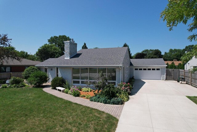 7744 2nd Ave, Kenosha, WI 53143 - ranch-style home with fence, a front lawn, an attached garage, a chimney, and driveway