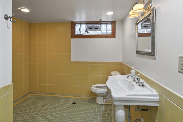 7744 2nd Ave, Kenosha, WI 53143 - bathroom featuring walk in shower, a sink, toilet, recessed lighting, and wainscoting