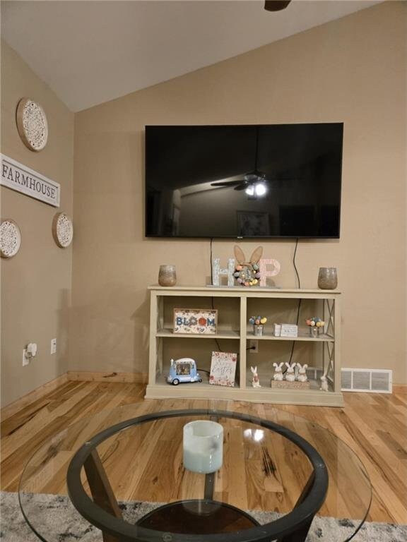 E8577 N County Rd, Elk Mound, WI 54739 - living area featuring wood finished floors, ceiling fan, vaulted ceiling, and visible vents