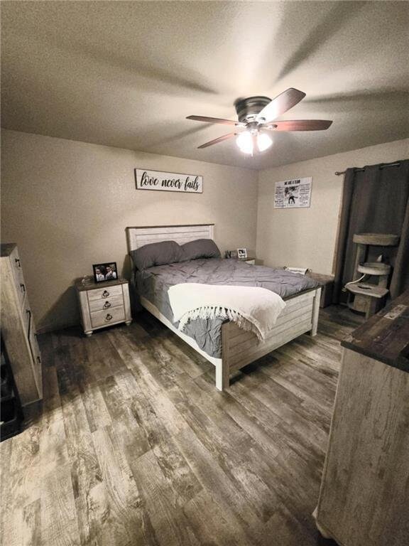 E8577 N County Rd, Elk Mound, WI 54739 - bedroom with ceiling fan, a textured ceiling, and dark wood finished floors