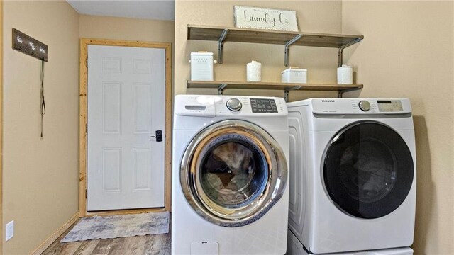 E8577 N County Rd, Elk Mound, WI 54739 - washroom featuring independent washer and dryer, laundry area, wood finished floors, and baseboards