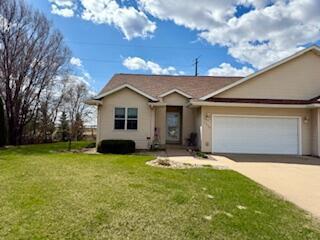 1330 Harvest Cir, Holmen, WI 54636 - single story home with concrete driveway, an attached garage, a front yard, and stucco siding