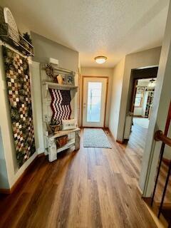1330 Harvest Cir, Holmen, WI 54636 - mudroom with wood finished floors, baseboards, and a textured ceiling