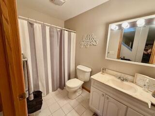 1330 Harvest Cir, Holmen, WI 54636 - full bathroom with vanity, toilet, tile patterned floors, and a shower with shower curtain