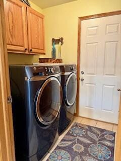 1330 Harvest Cir, Holmen, WI 54636 - laundry room featuring washing machine and dryer, cabinet space, and light tile patterned floors