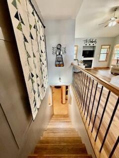 1330 Harvest Cir, Holmen, WI 54636 - staircase with a ceiling fan, wood finished floors, and a fireplace