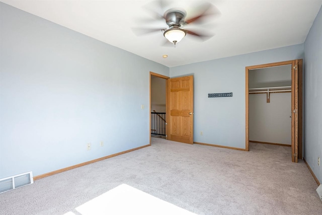 unfurnished bedroom featuring visible vents, baseboards, carpet flooring, and a closet